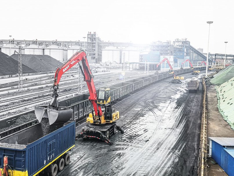 A face shovel crawler excavator for loading vessels with wood chippings